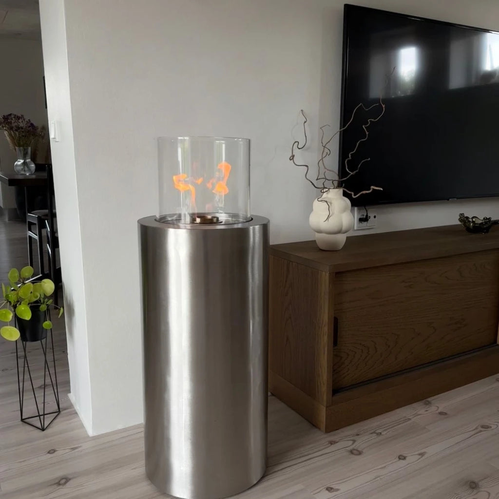 ScandiFlames Dualis bioethanol fireplace with a brushed steel fireplace body and a cylindrical safety glass