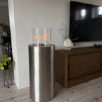 ScandiFlames Dualis bioethanol fireplace with a brushed steel fireplace body and a cylindrical safety glass