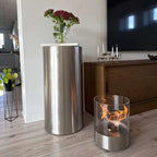 ScandiFlames Dualis bioethanol fireplace with a brushed steel fireplace body and a cylindrical safety glass
