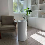 ScandiFlames Dualis bioethanol fireplace with a white fireplace body and a cylindrical safety glass