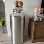 ScandiFlames Dualis bioethanol fireplace with a brushed steel fireplace body and a cylindrical safety glass
