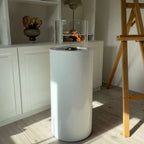 ScandiFlames Dualis bioethanol fireplace with a white fireplace body and a cylindrical safety glass