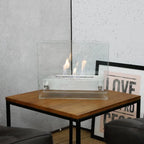 Small tabletop bio fireplace of steel and glass
