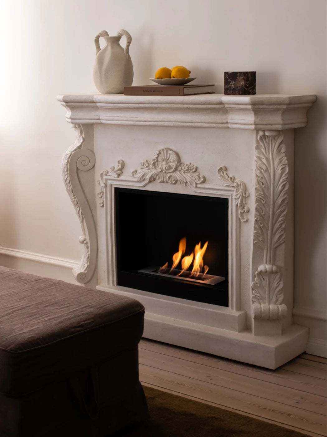 Ymir freestanding bioethanol fireplace with grey polystone surround